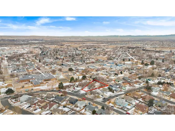 an aerial view of residential houses with city view