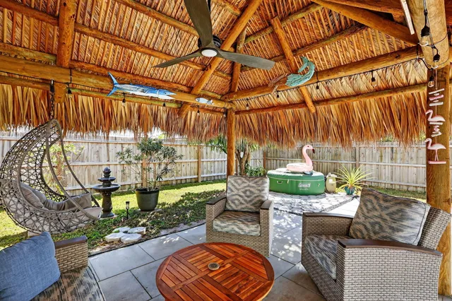 a view of backyard of house with seating space