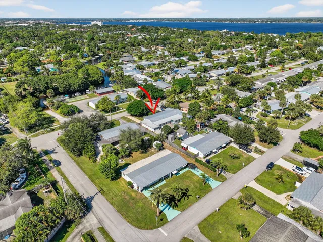 an aerial view of a house with a yard and garden