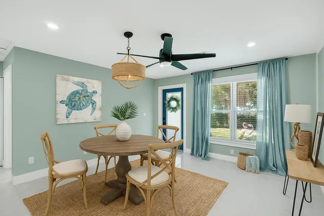 a dining room with furniture a rug and a chandelier