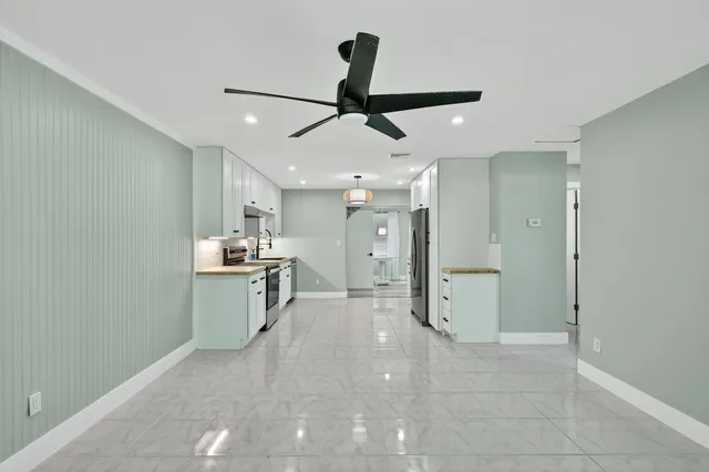 a view of a kitchen with a sink and refrigerator