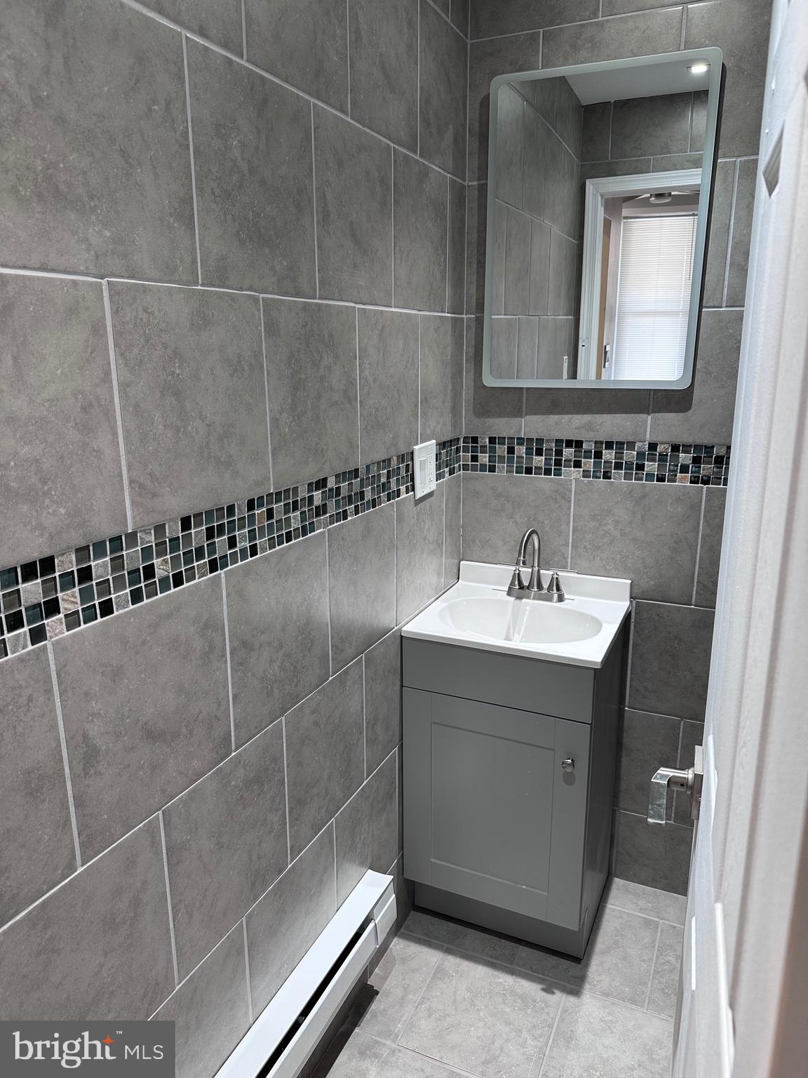 5254 Jefferson Street Philadelphia, PA 19131 - Photo 11 of 30 a bathroom with a sink and mirror