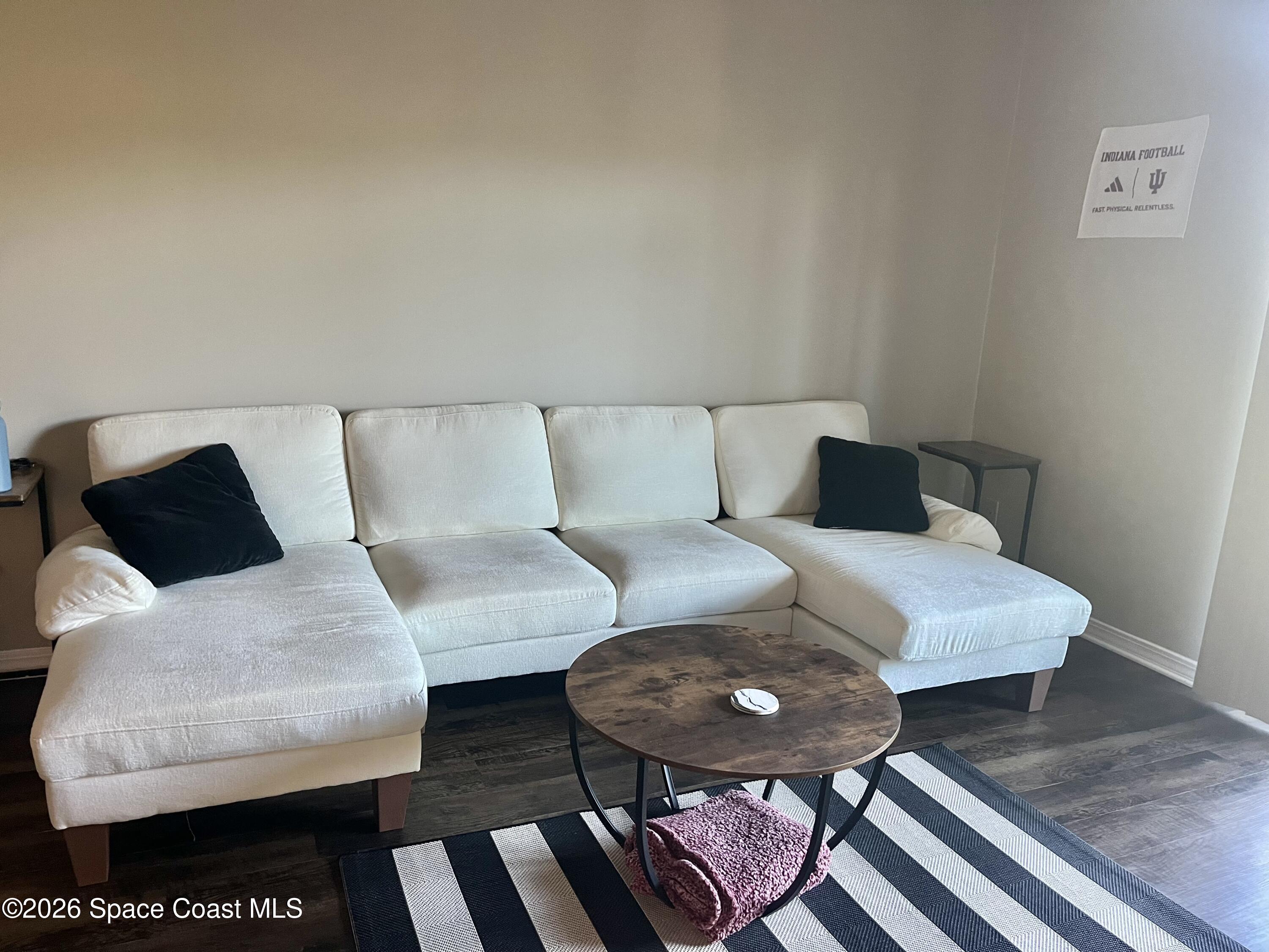 7667 North Wickham Road, Unit 1118 Melbourne, FL 32940 - Photo 6 of 26 a living room with furniture and a rug
