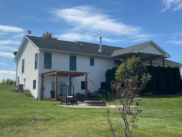 1869 East Town Line Road Oregon, IL 61061 - Photo 3 of 45 a front view of a house with garden