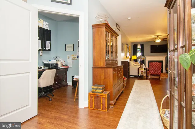 a living room with furniture a large window wooden floor and a table