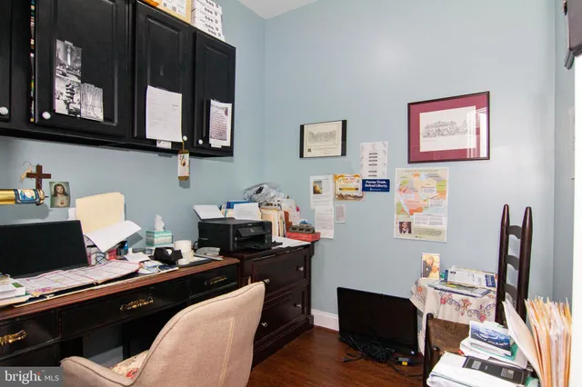 a view of a workspace with furniture and wooden floor