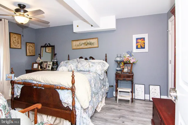 a bed sitting in a bedroom next to a window with a chandelier