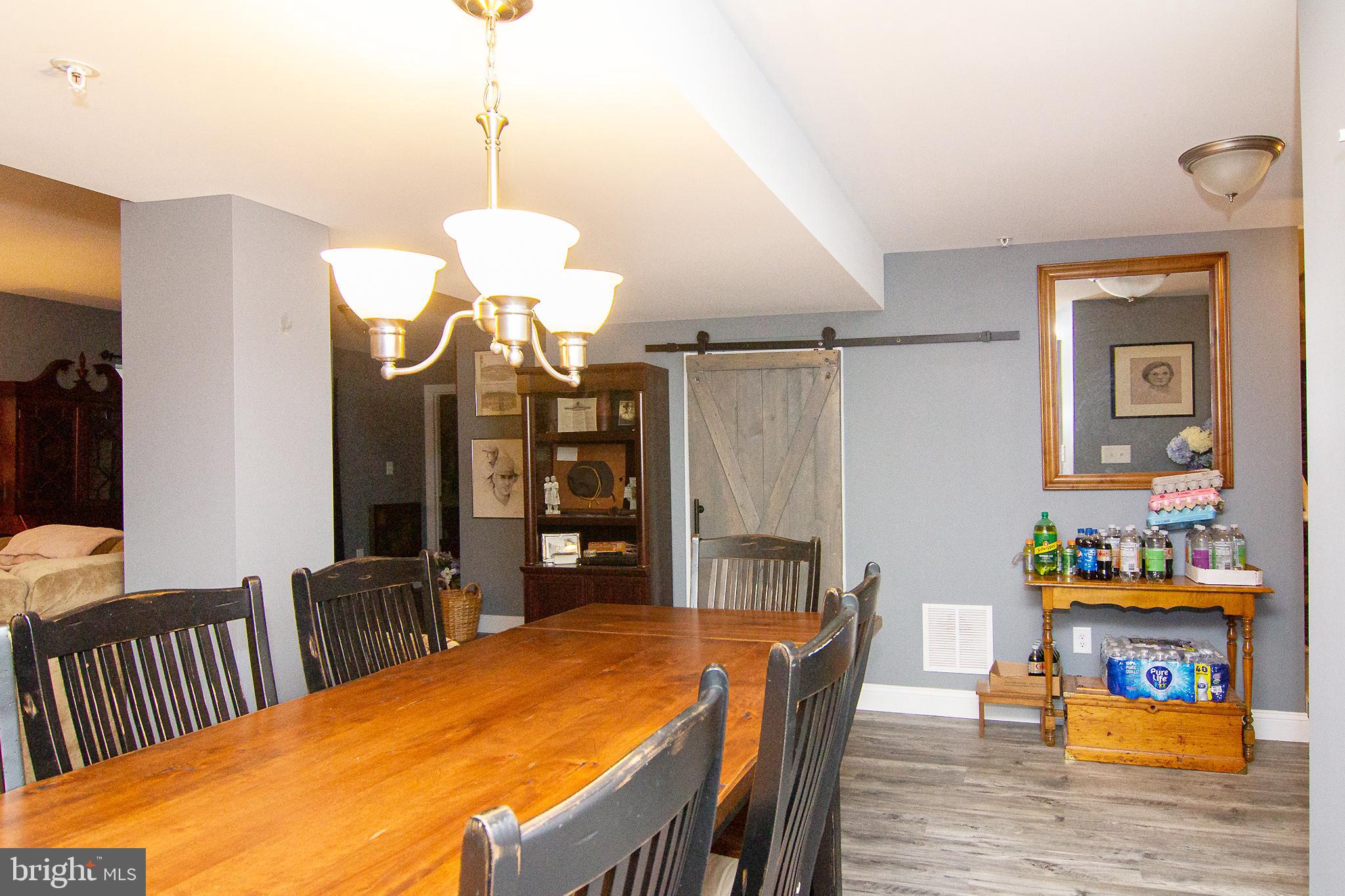 2785 Castlefield Drive, Unit 14 Manchester, MD 21102 - Photo 39 of 42 a dining room with furniture and wooden floor