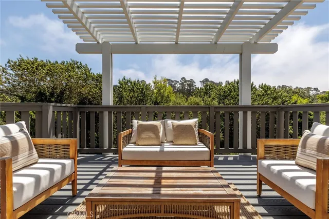 a view of a patio with couches chairs and wooden floor