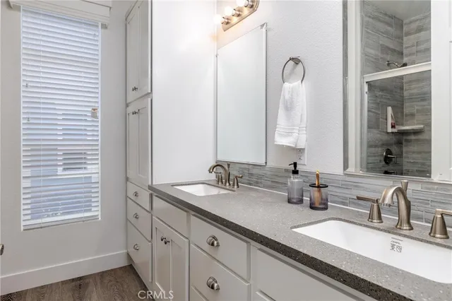 a bathroom with a double vanity sink and a mirror