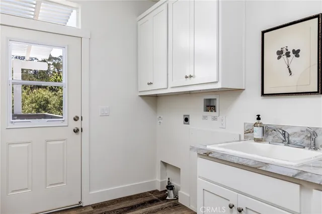 a bathroom with a granite countertop sink and a window