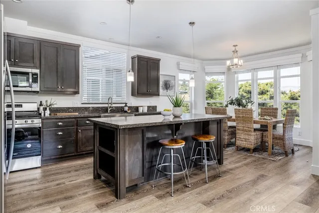 a kitchen with a table chairs stove and cabinets