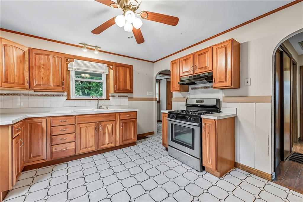 66 Concord Road Hermitage, PA 16148 - Photo 13 of 21 a kitchen with stainless steel appliances granite countertop a stove top oven a sink a dining table and chairs
