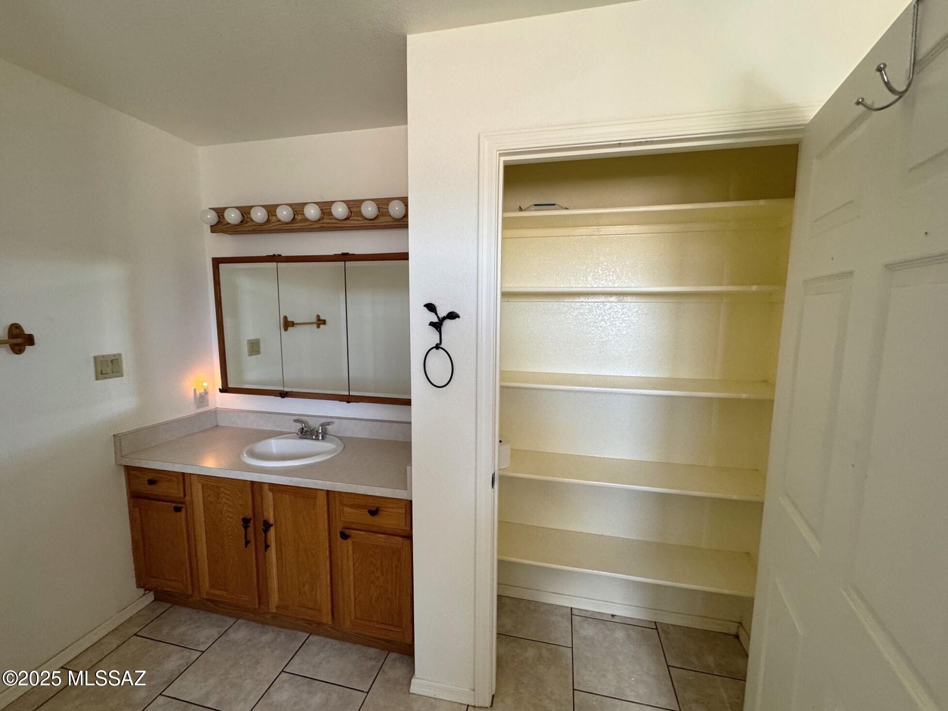 13384 South Cottonwood Road Pearce, AZ 85625 - Photo 20 of 46 a bathroom with a sink and a mirror