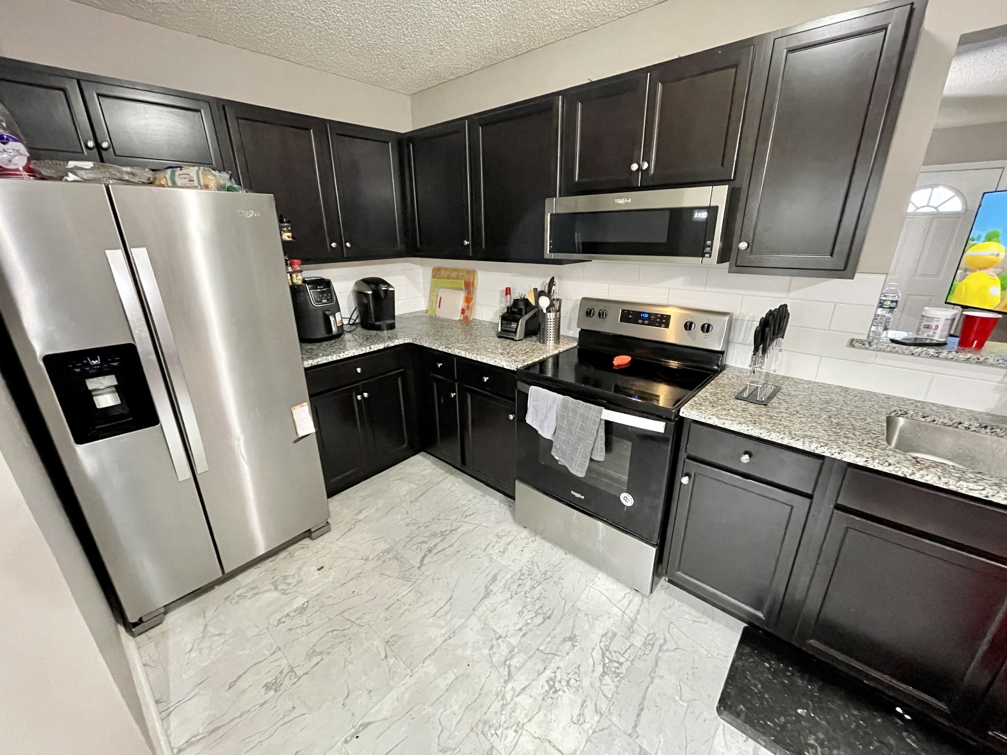 710 Hugh Hunter Road Oak Grove, KY 42262 - Photo 11 of 12 a kitchen with stainless steel appliances granite countertop a refrigerator stove a sink dishwasher and microwave