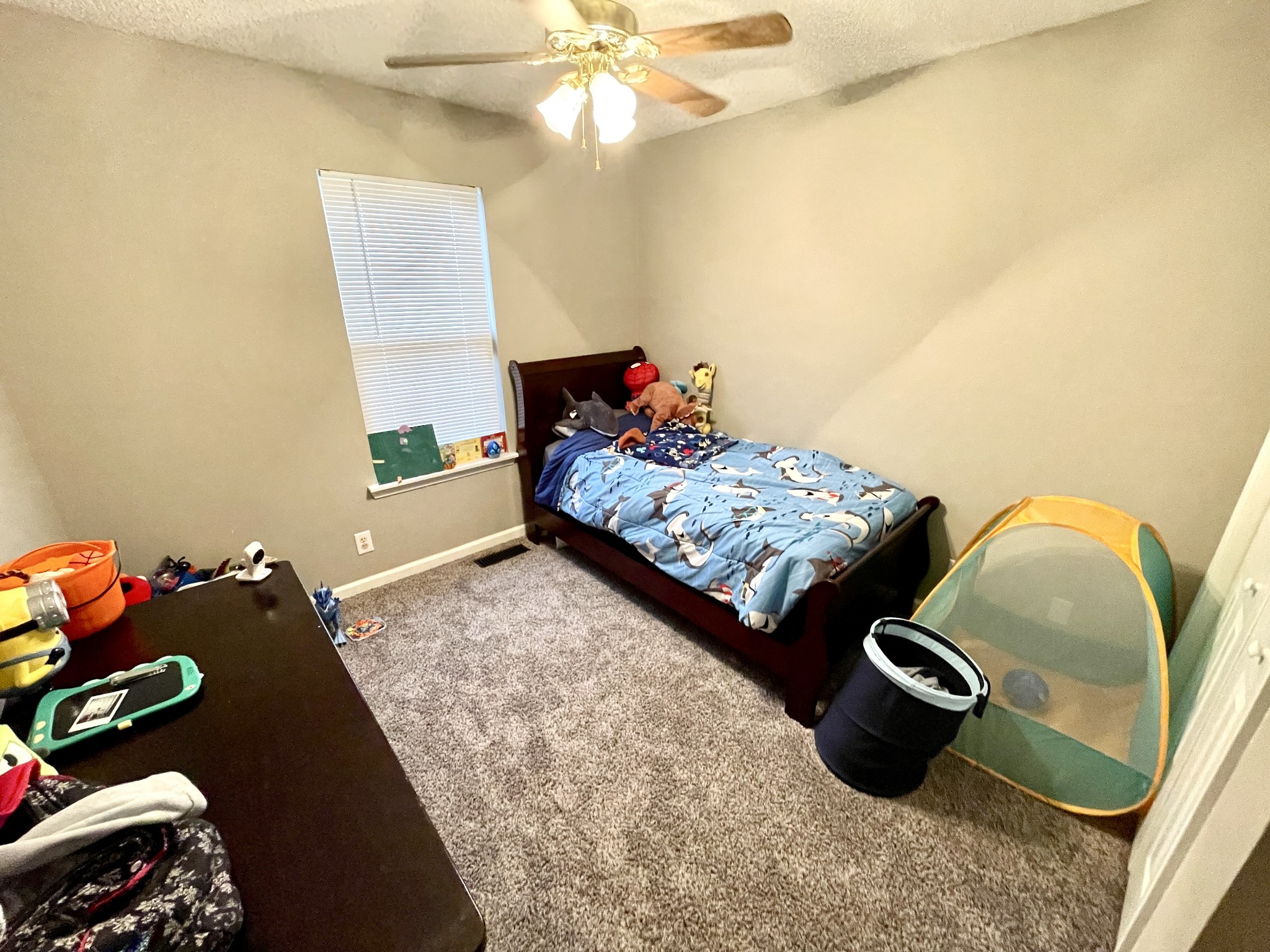 710 Hugh Hunter Road Oak Grove, KY 42262 - Photo 9 of 12 a bedroom with a bed and a chandelier