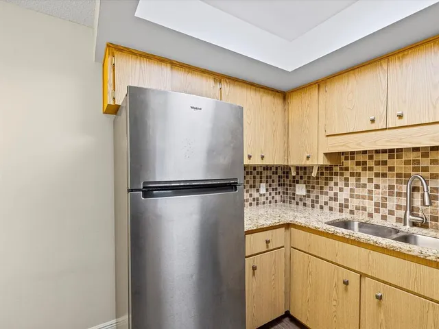 a white refrigerator freezer sitting in a kitchen
