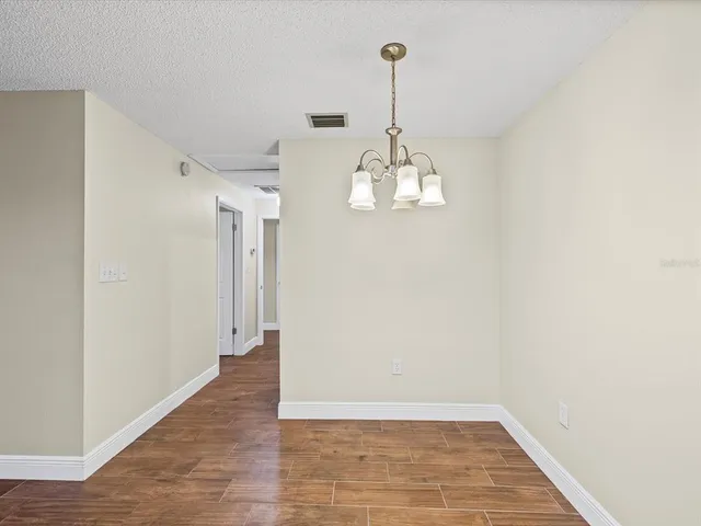 a view of a room with a sink and chandelier