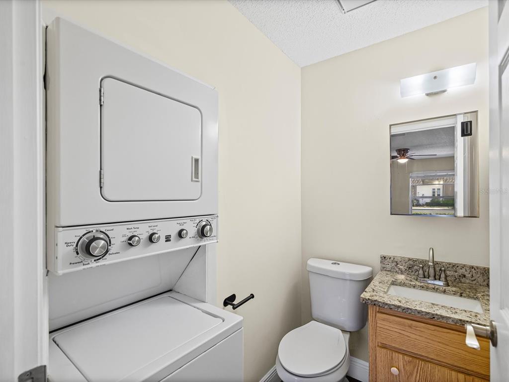 6037 Chesham Drive, Unit 7 New Port Richey, FL 34653 - Photo 21 of 29 a white toilet sitting next to a bathroom sink