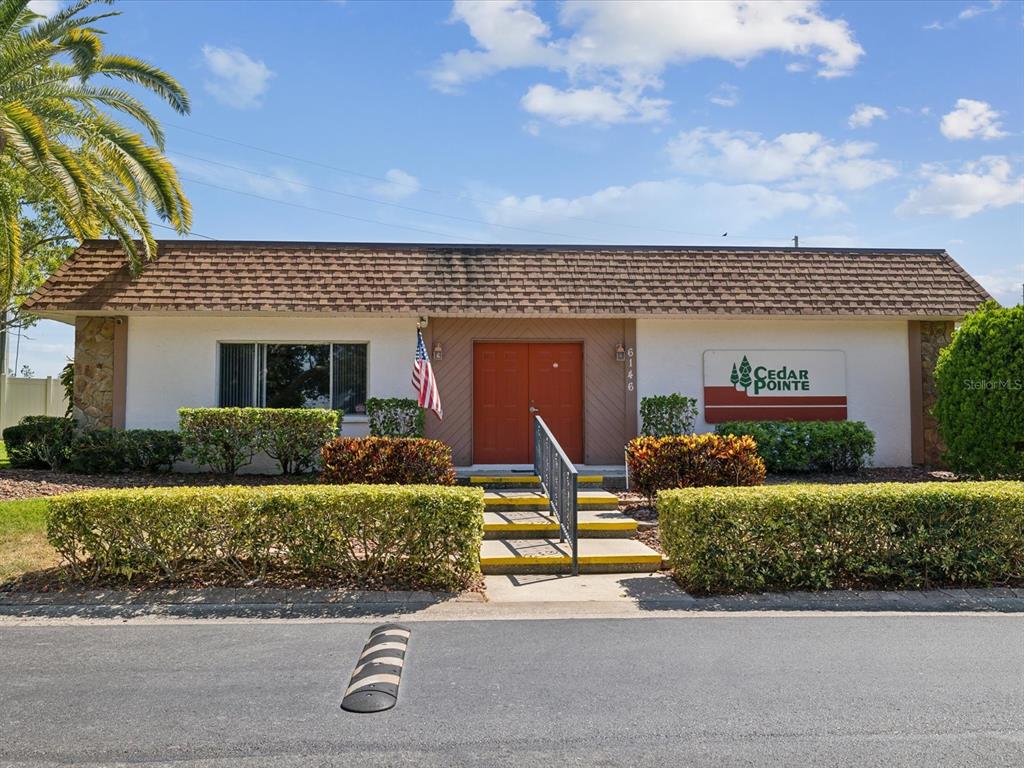 6037 Chesham Drive, Unit 7 New Port Richey, FL 34653 - Photo 26 of 29 a front view of a house with garden