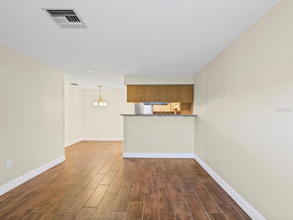 6037 Chesham Drive, Unit 7 New Port Richey, FL 34653 - Photo 5 of 29 a view of a kitchen with wooden floor