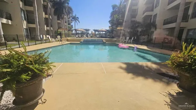 a view of a swimming pool with a yard