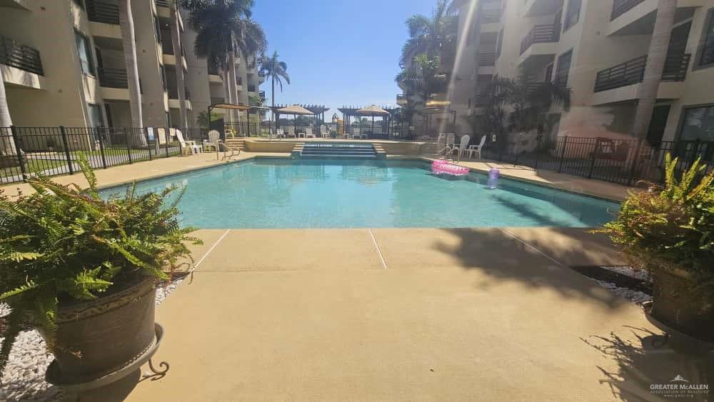 813 Travis Street, Unit 210 Mission, TX 78572 - Photo 13 of 13 a view of a swimming pool with a yard
