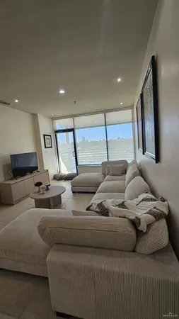 a living room with furniture and a large window