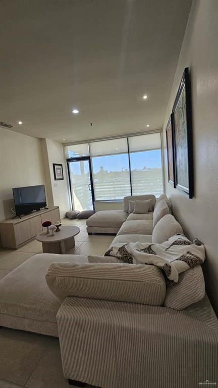 813 Travis Street, Unit 210 Mission, TX 78572 - Photo 4 of 13 a living room with furniture and a large window