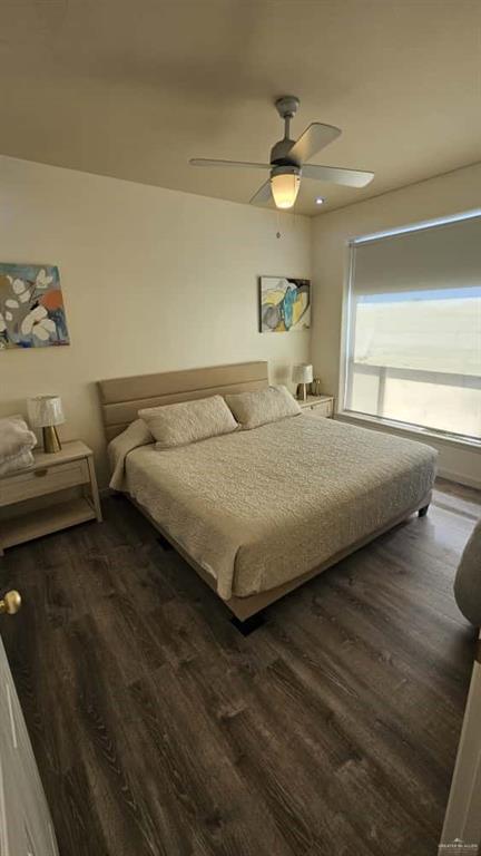 813 Travis Street, Unit 210 Mission, TX 78572 - Photo 5 of 13 a bedroom with a bed and a chandelier