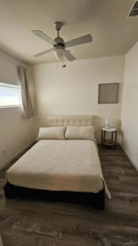 a large bed sitting in a bedroom next to a window