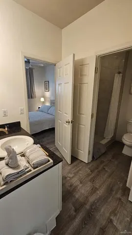 a living room with a bed furniture and a refrigerator