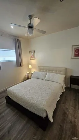 a bedroom with a bed and a lamp on table