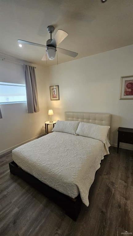 813 Travis Street, Unit 210 Mission, TX 78572 - Photo 10 of 13 a bedroom with a bed and a lamp on table