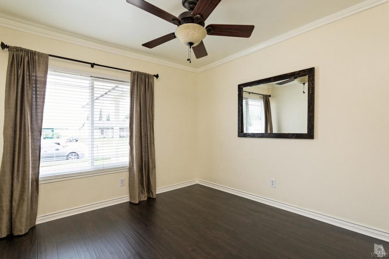 6449 Keystone Street Simi Valley, CA 93063 - Photo 14 of 20 a view of an empty room with a window and wooden floor