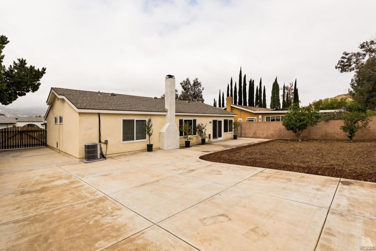 6449 Keystone Street Simi Valley, CA 93063 - Photo 19 of 20 a front view of a house with a yard and garage