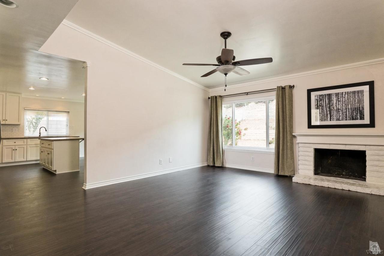 6449 Keystone Street Simi Valley, CA 93063 - Photo 4 of 20 a view of an empty room with window and wooden floor