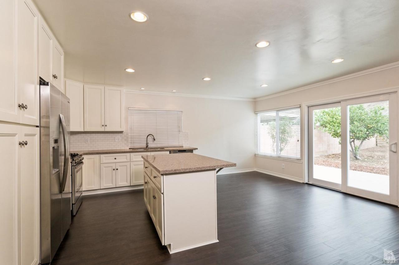 6449 Keystone Street Simi Valley, CA 93063 - Photo 5 of 20 a kitchen with a stove a sink and a refrigerator