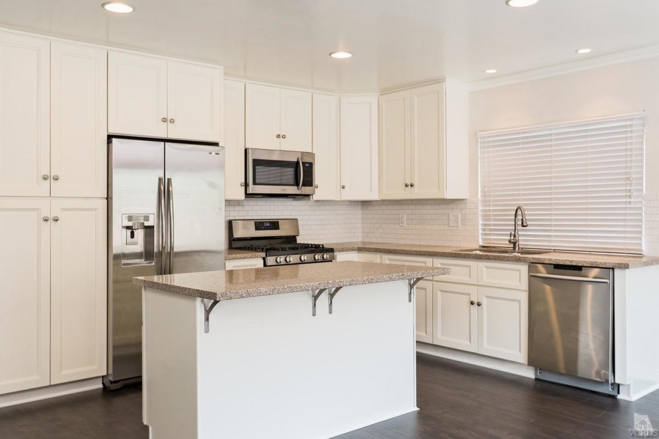 6449 Keystone Street Simi Valley, CA 93063 - Photo 6 of 20 a kitchen with stainless steel appliances granite countertop a stove a sink a refrigerator and white cabinets