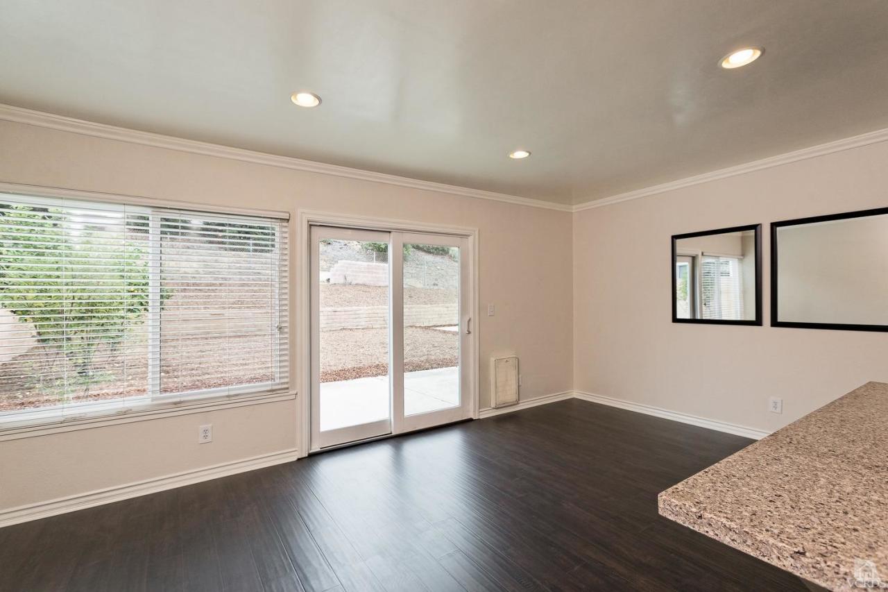 6449 Keystone Street Simi Valley, CA 93063 - Photo 9 of 20 a view of an empty room with wooden floor and a window