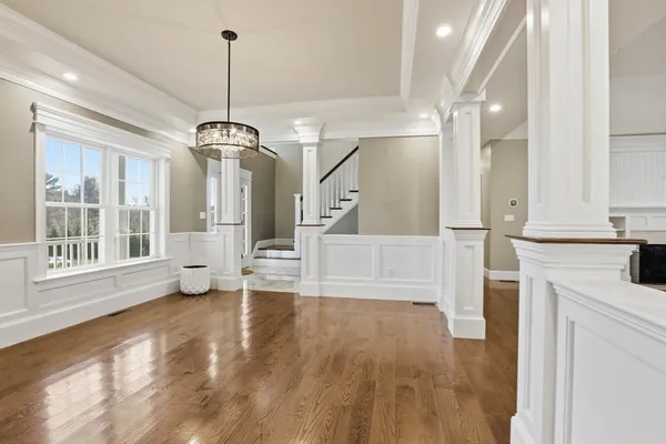 a view of a room with wooden floor and staircase