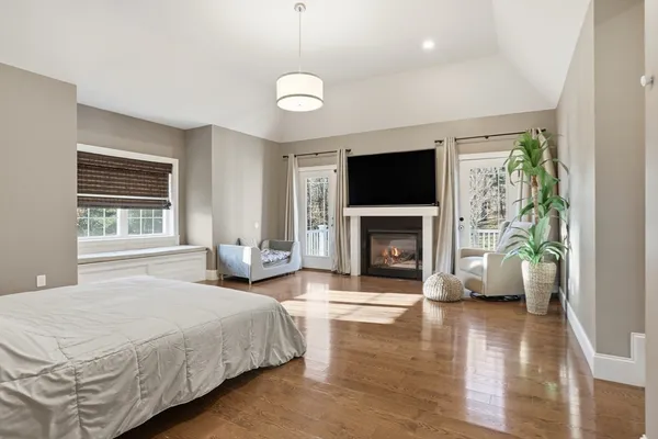 a spacious bedroom with a bed and a flat screen tv