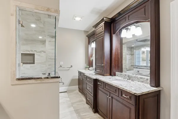 a bathroom with a granite countertop sink and a mirror