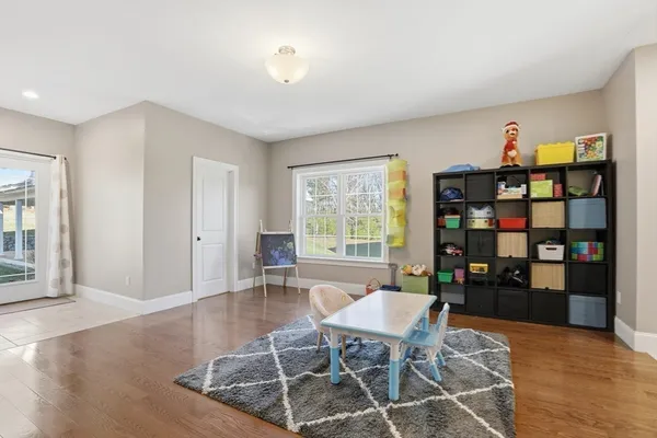 a dining room with furniture and wooden floor