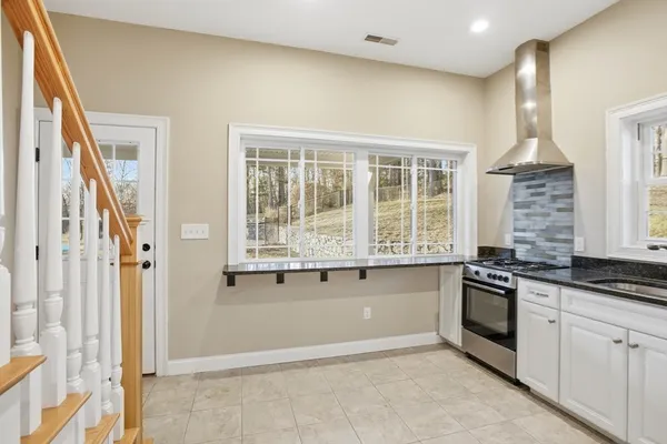 a kitchen with granite countertop a stove and a sink