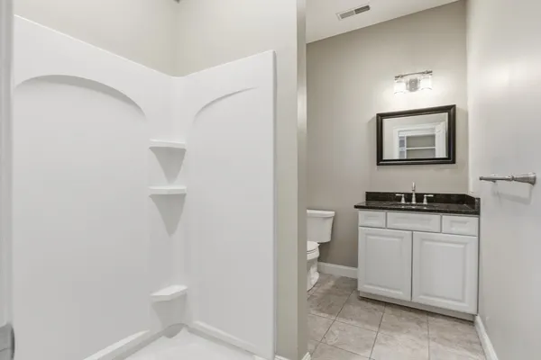 a bathroom with a toilet a sink and a mirror
