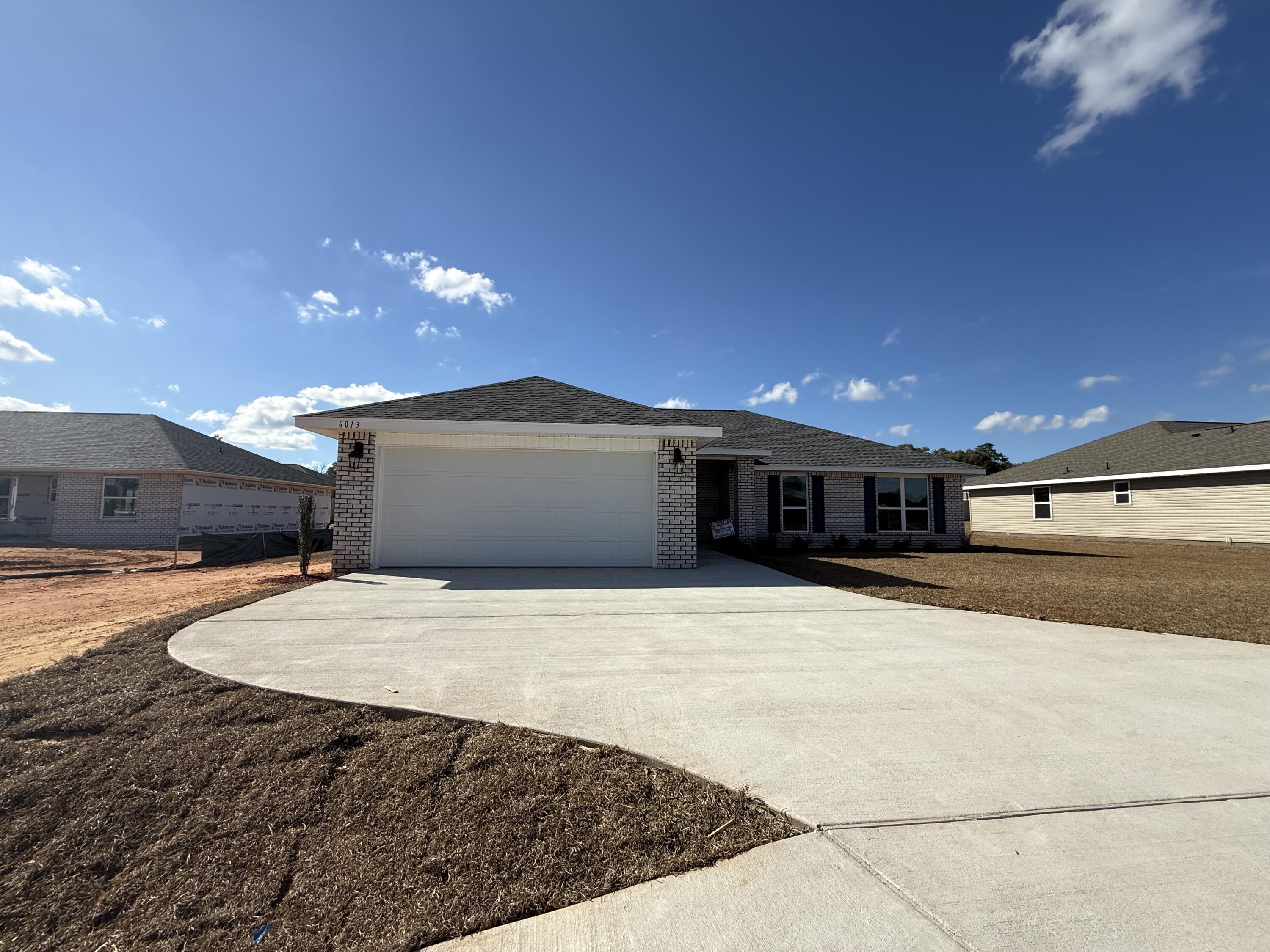 6013 Crocket Cove Crestview, FL 32539 - Photo 1 of 27 a large kitchen with stainless steel appliances a large island in the middle of a room