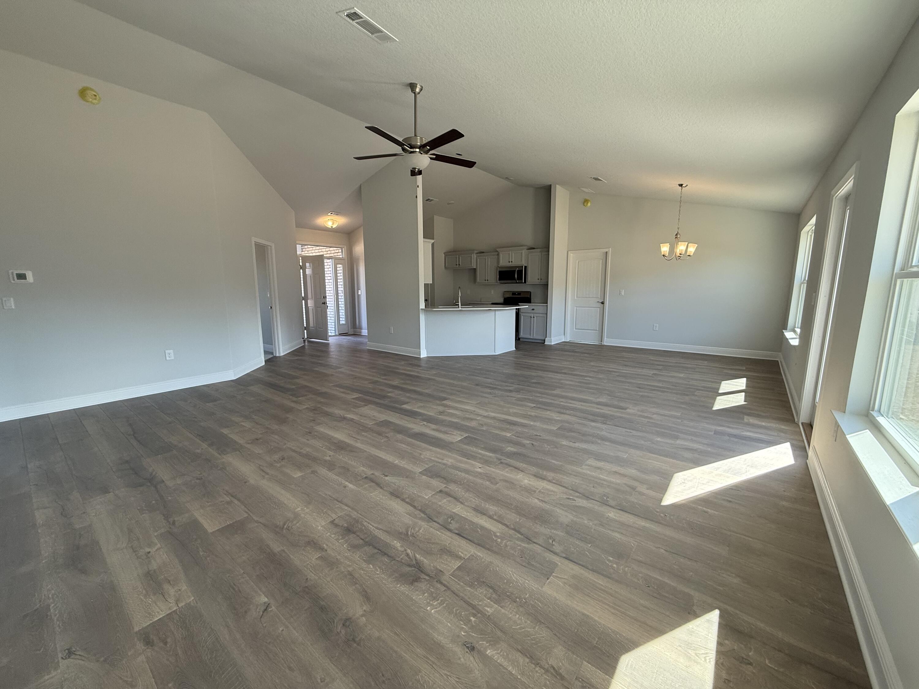 6013 Crocket Cove Crestview, FL 32539 - Photo 13 of 27 a view of empty room with wooden floor and fan