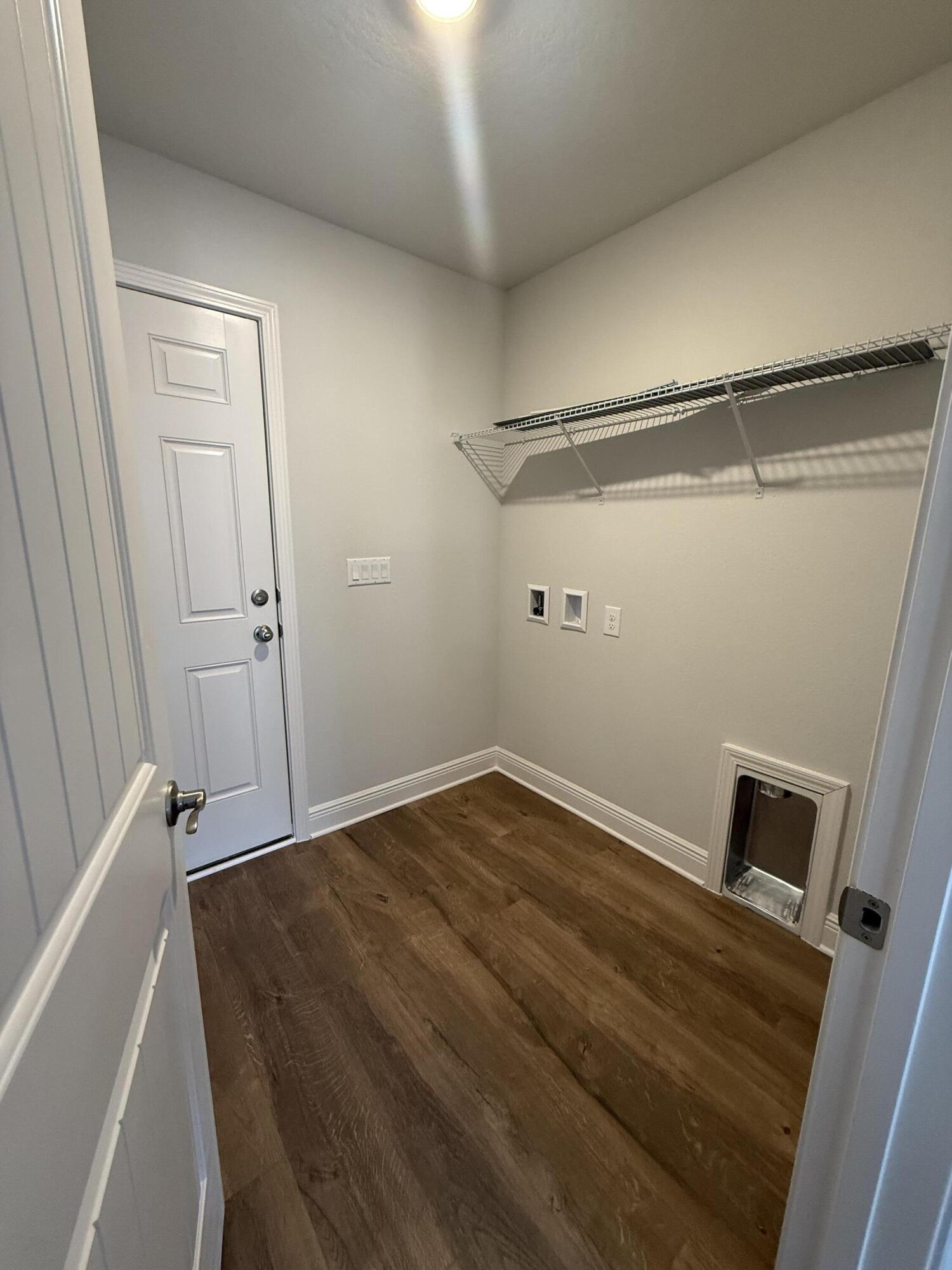 6013 Crocket Cove Crestview, FL 32539 - Photo 16 of 27 a view of a room with wooden floor and white walls