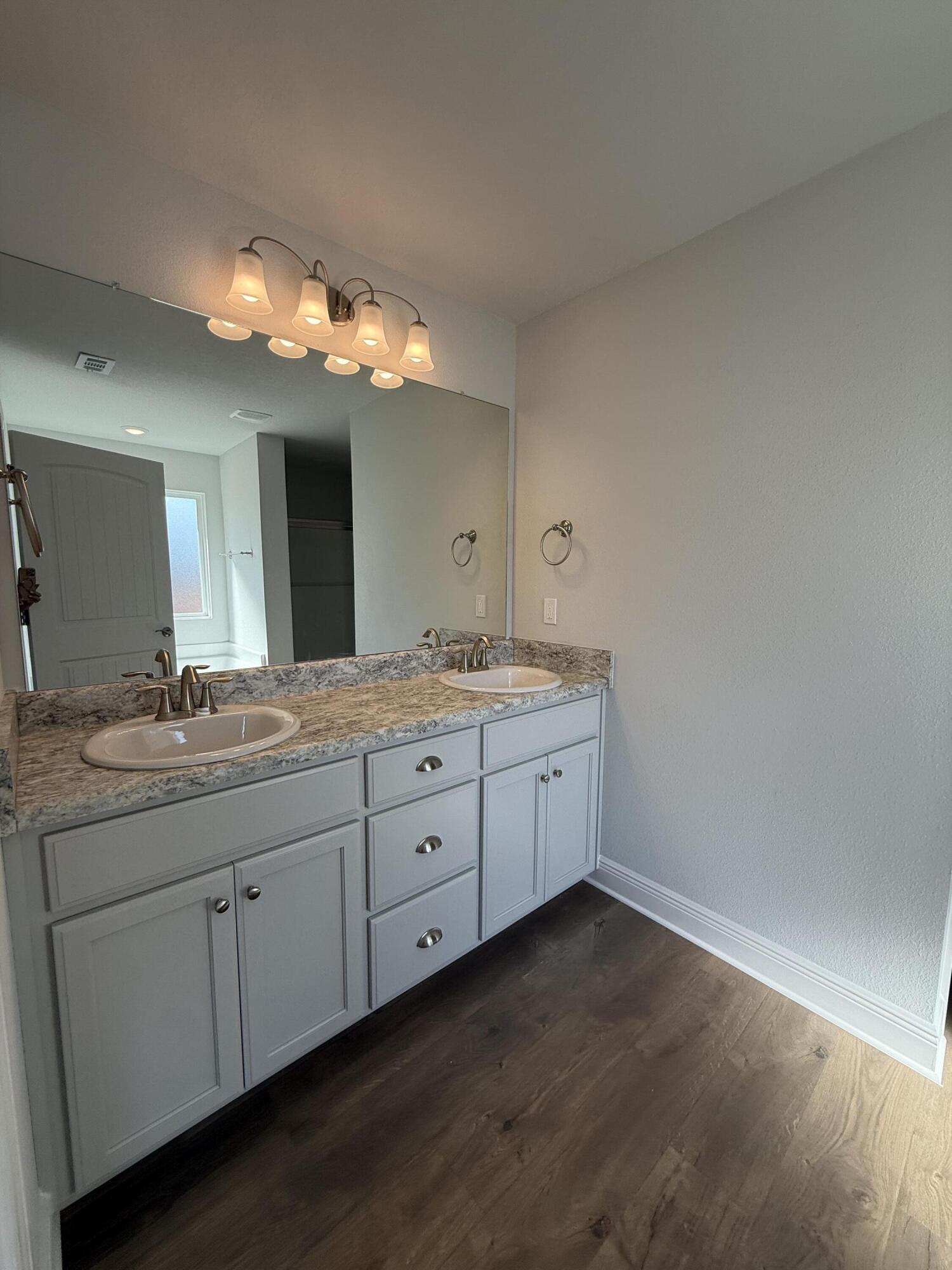6013 Crocket Cove Crestview, FL 32539 - Photo 22 of 27 a bathroom with a granite countertop sink and a mirror